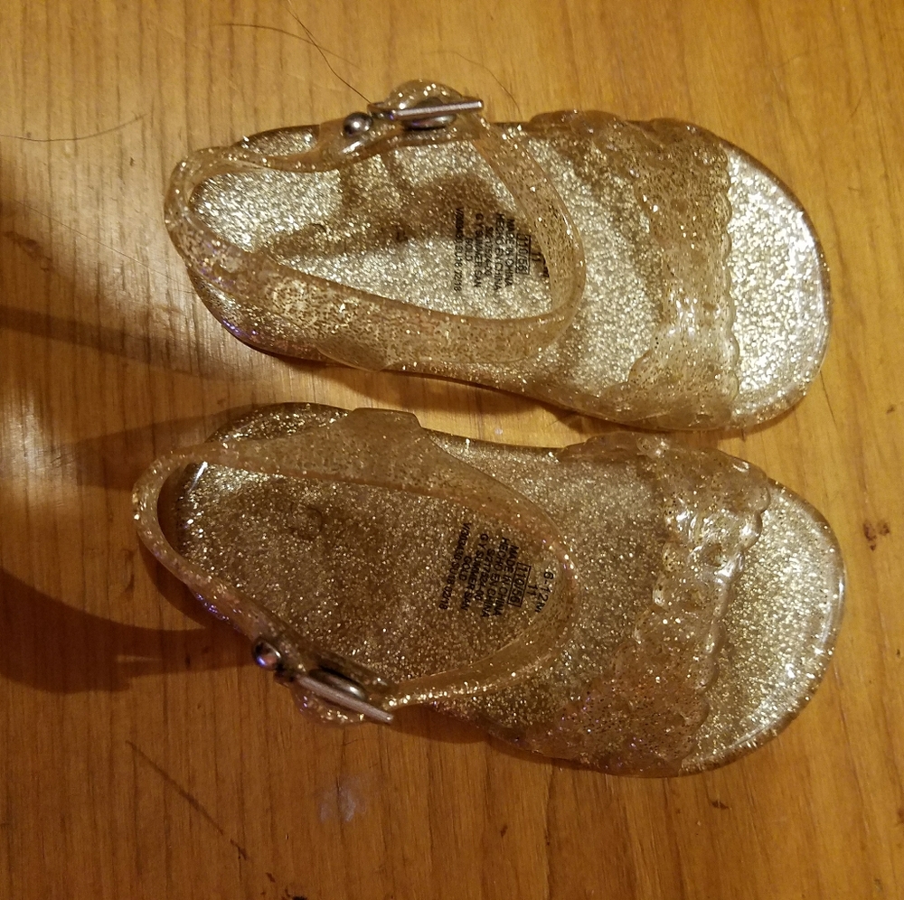 Pair of gold jelly sandals.